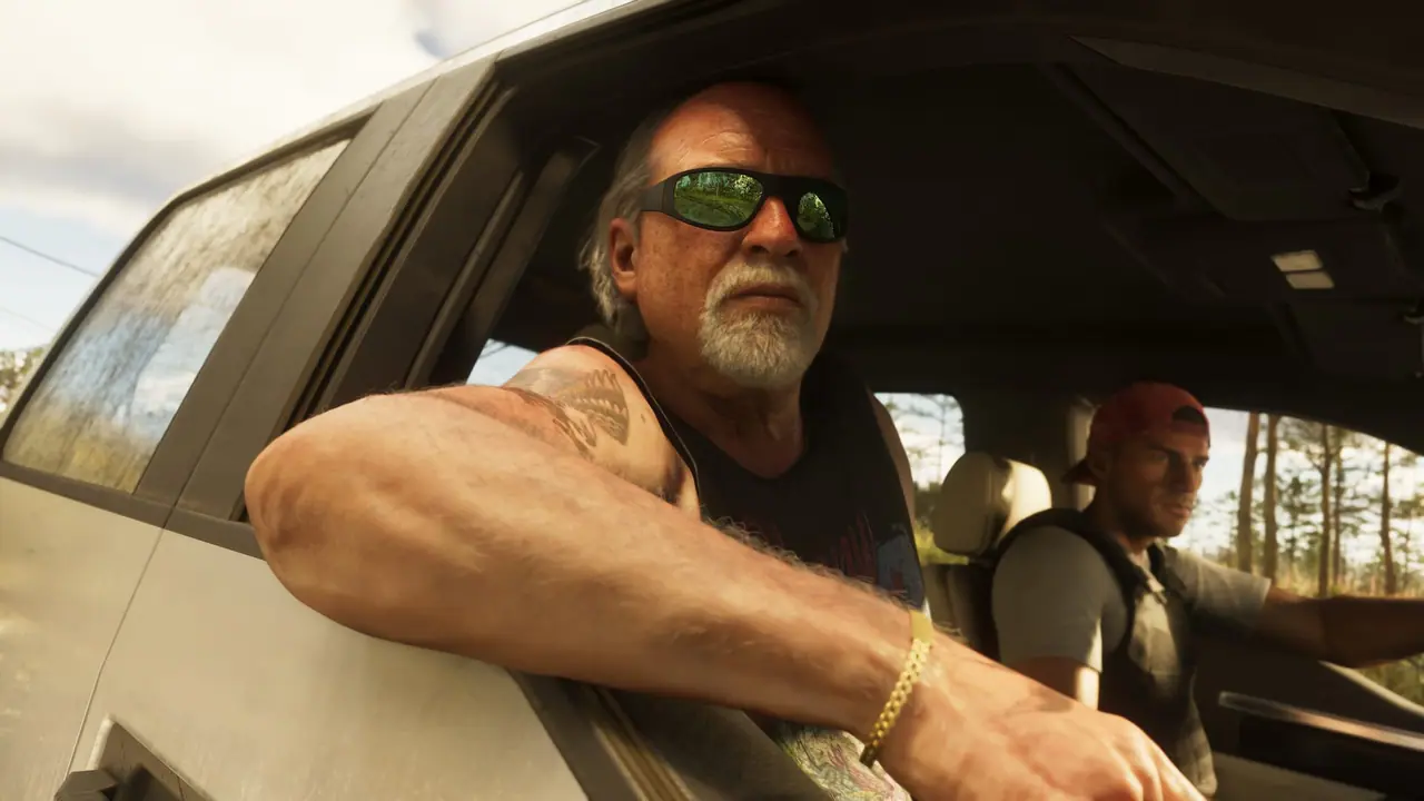 Brian Heder in sunglasses leaning out of a pickup's window, a younger man in the passenger seat