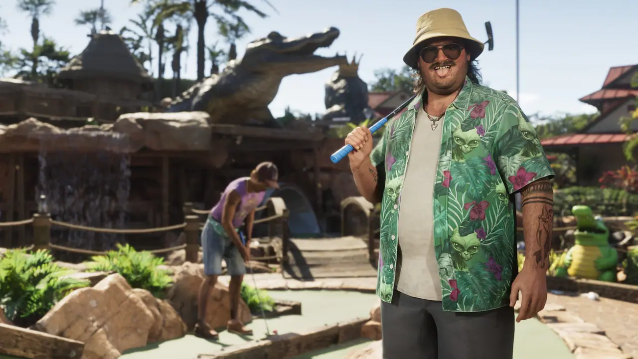 Cal Hampton in a bucket hat and floral shirt holding a putter at a mini-golf course with a giant alligator statue