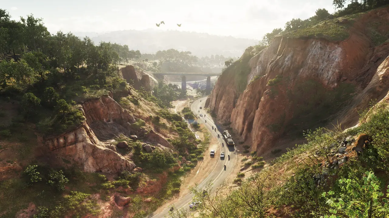 A highway winding through a canyon of red cliffs and forest in Mount Kalaga