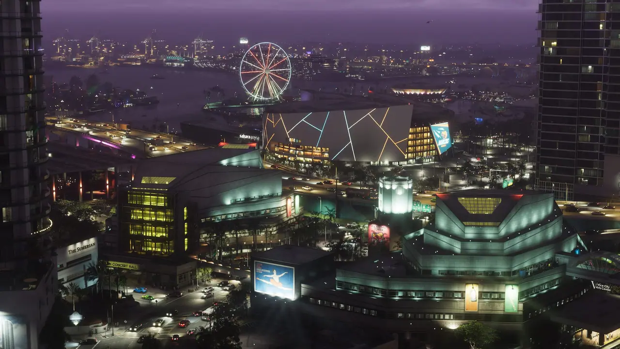 Vice City at night from above: a lit Ferris wheel, an arena and glowing towers